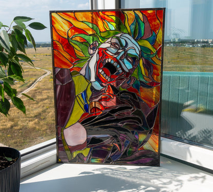 Creepy clown stained glass panel standing on windowsill with outdoor field view, bold comic villain dark art handmade glass