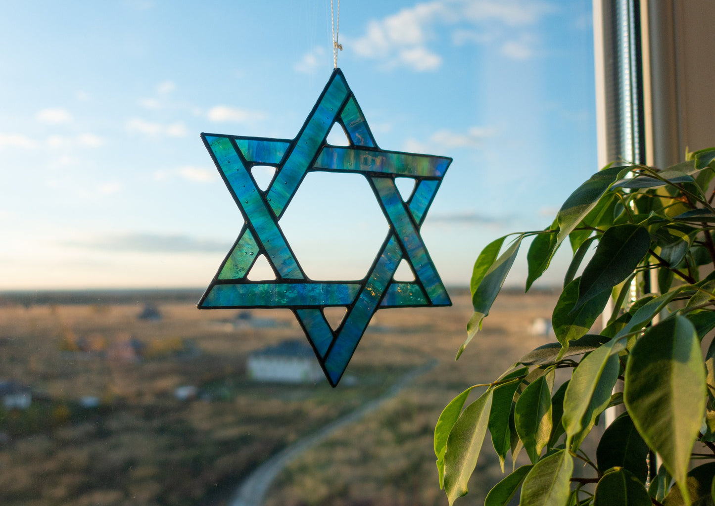Stained glass Star of David close-up — black patina finish, six-pointed star, precise hand-cut glass