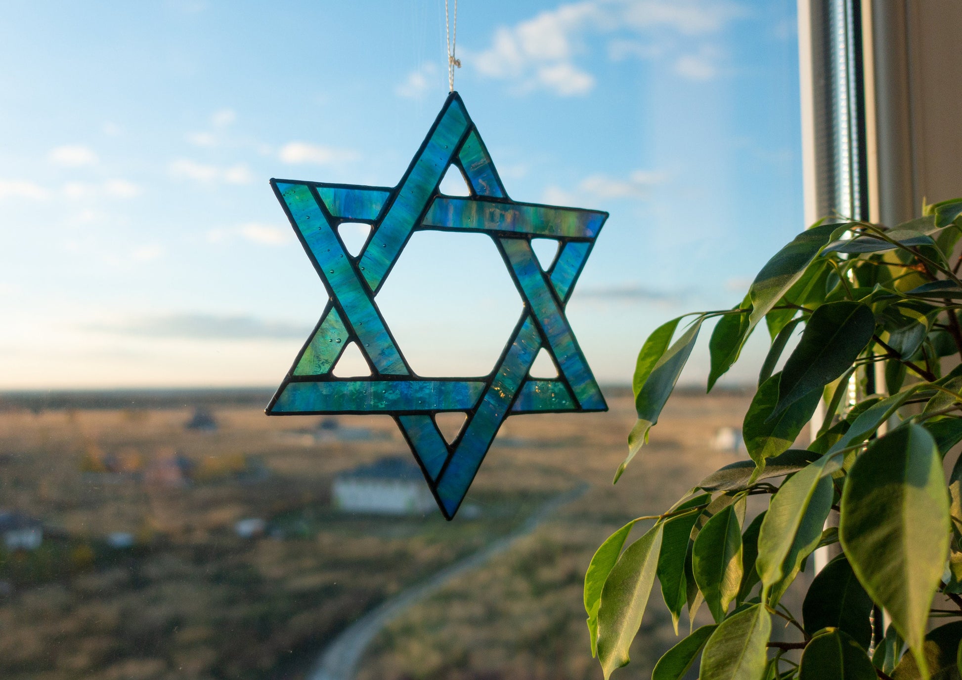Stained glass Star of David close-up — black patina finish, six-pointed star, precise hand-cut glass
