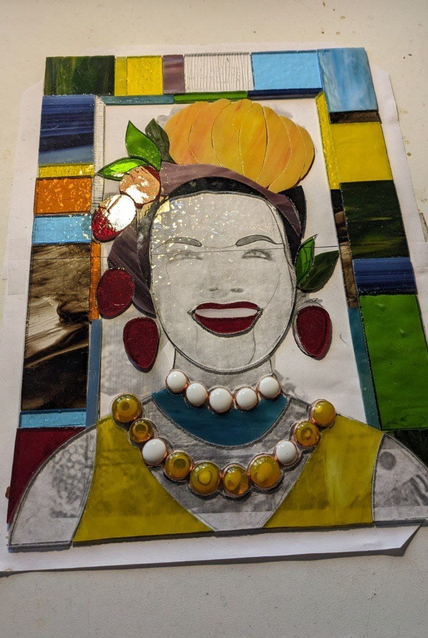 Mosaic artwork of a woman's face with colorful frame