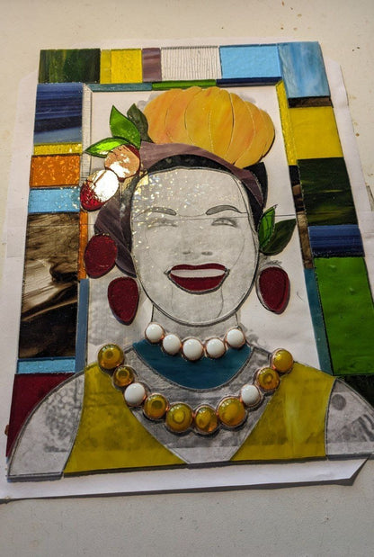Mosaic artwork of a woman's face with colorful frame