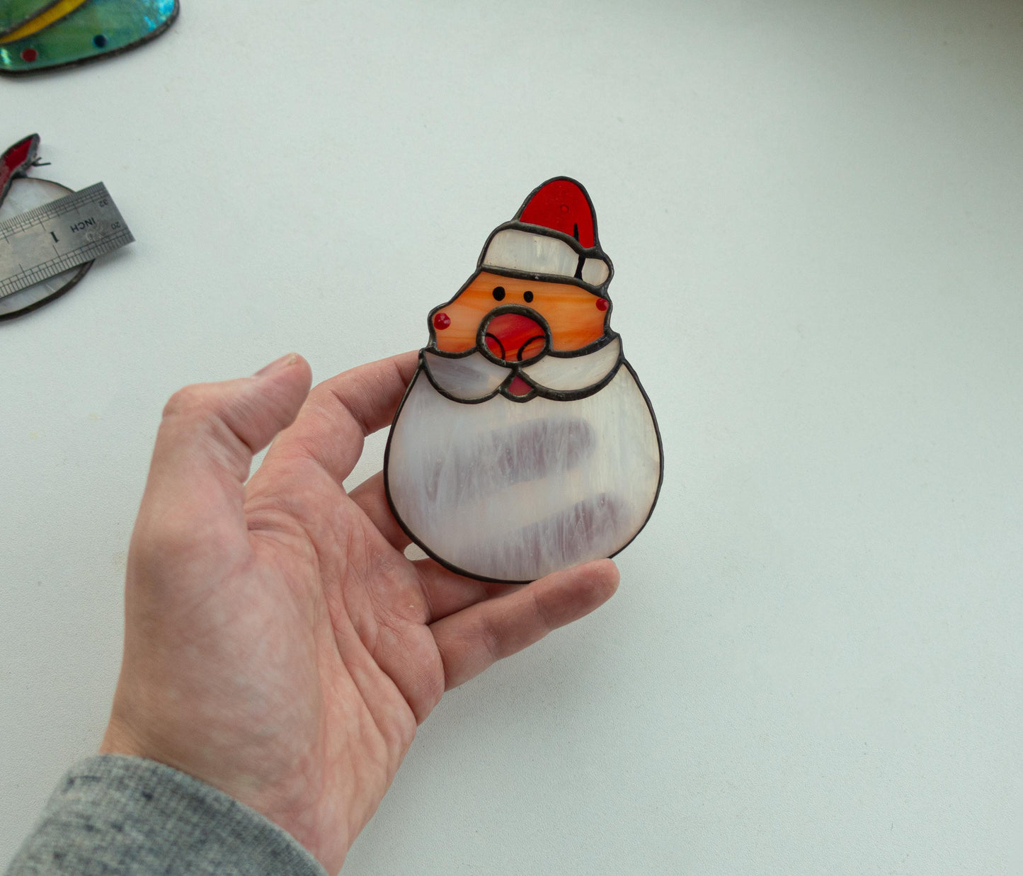 Santa Claus suncatcher hanging in window — Christmas light catcher, premium holiday window art