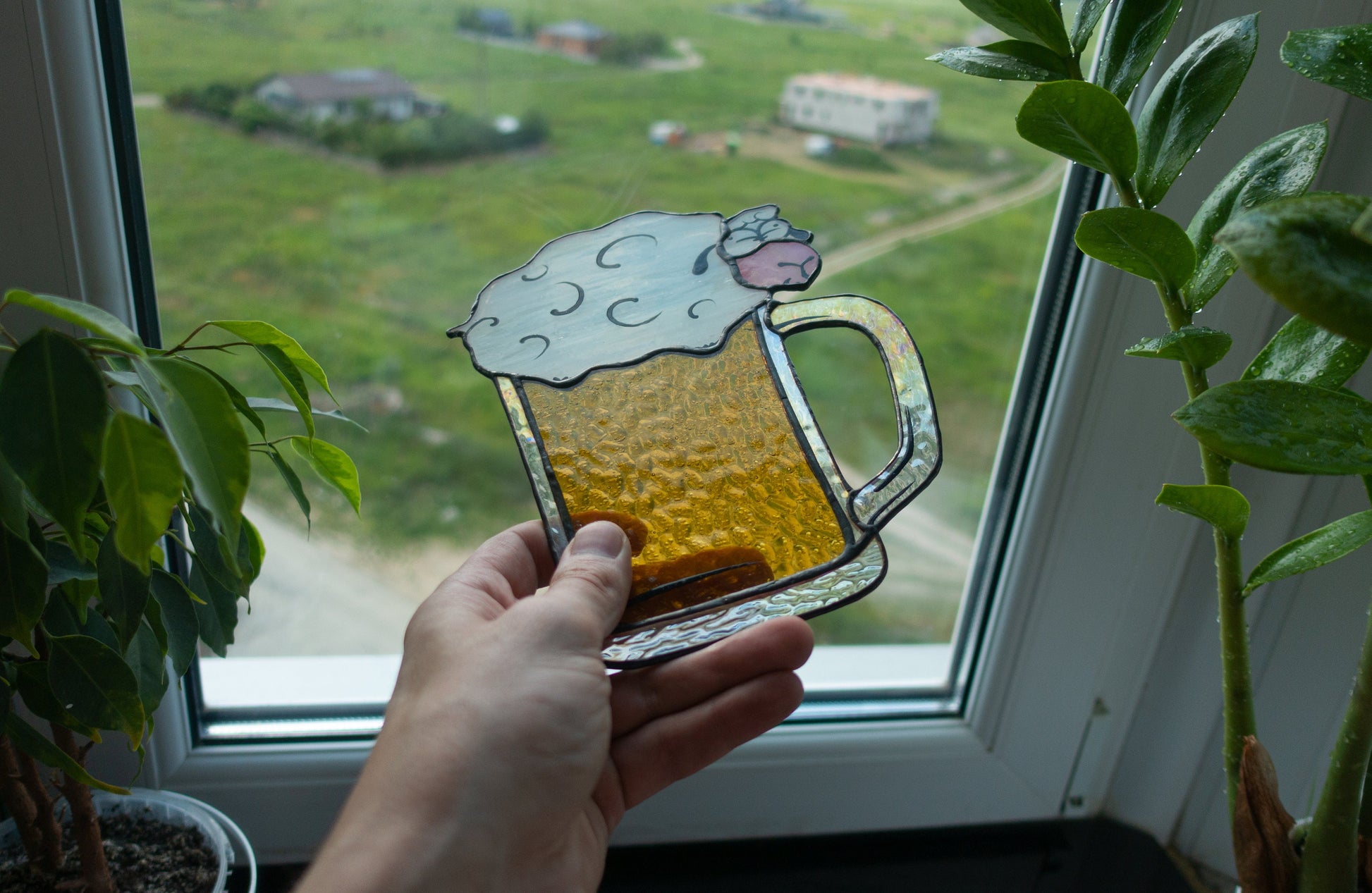 Stained glass beer pint suncatcher close-up — black patina finish, golden beer with fluffy sheep foam