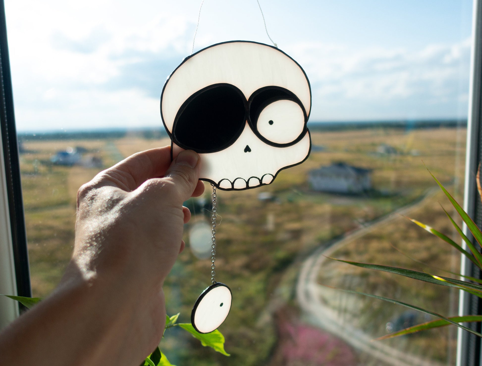 Handmade Halloween droopy eye skull stained glass suncatcher — spooky gothic window art horror lover gift