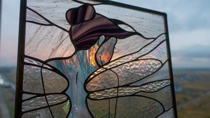  Close-up detail of stained glass fairy panel held against cloudy sky at sunset, iridescent dragonfly wings with burgundy hair bun, copper foil lead lines