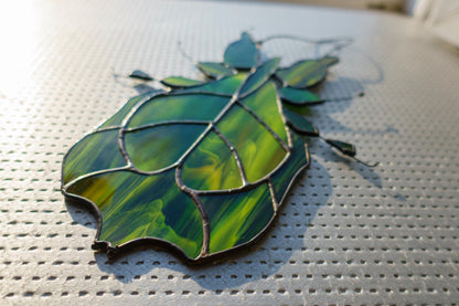 Stained glass leaf insect close-up — organic vein detail, black patina finish, hand-cut glass shape