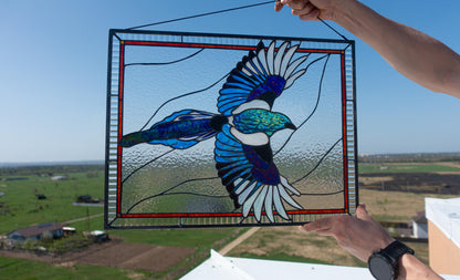 Comparison of old black vs new black iridescent glass in magpie stained glass panel — shows color shift effect of specialty iridescent glass