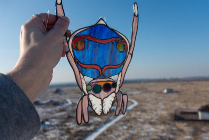 Maratus volans peacock spider stained glass — shifting blue red gold iridescent fan, copper foil Tiffany method, Ukraine

