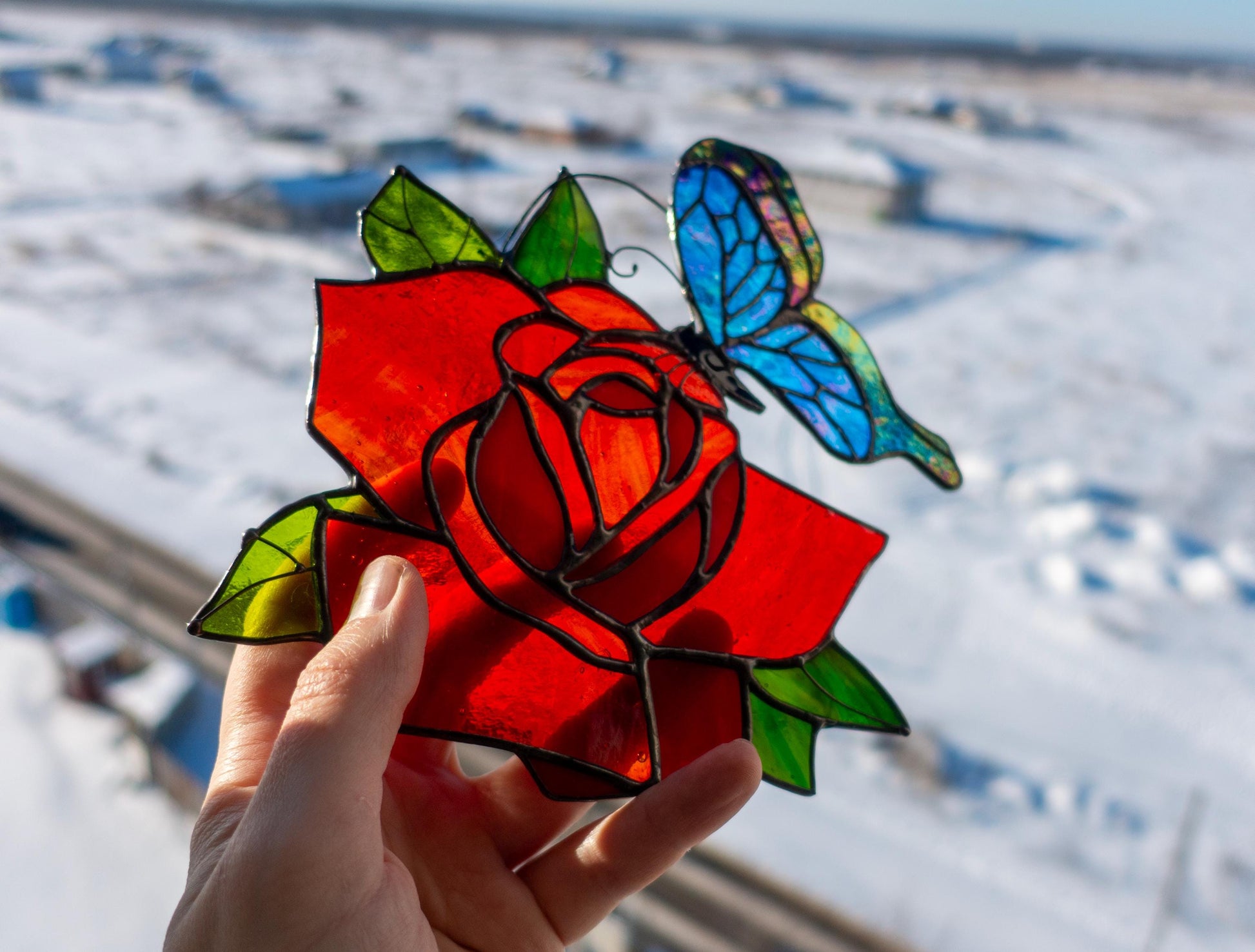 Tiffany copper foil stained glass rose suncatcher detail — hand-cut glass petals and butterfly wings
