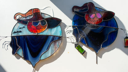 Halloween scarecrow suncatcher hanging in window — spooky lantern glow, gothic stained glass art