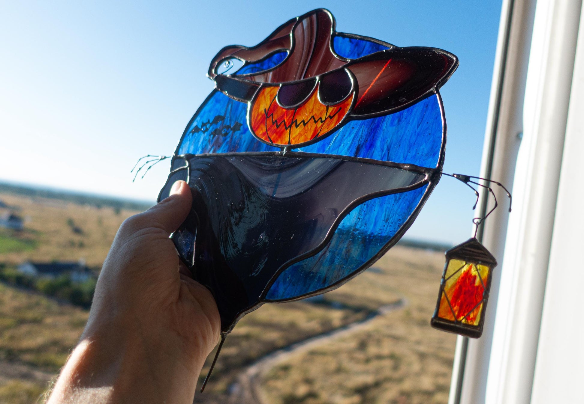 Stained glass pumpkin scarecrow close-up — black patina finish, dark blue midnight background variant