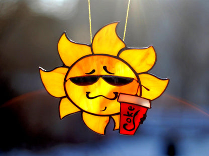 Handmade stained glass cool sun suncatcher — smiling sun in sunglasses with cola cup, Mojoartglass