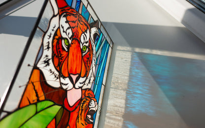 Stained glass panel with a tiger design on a window