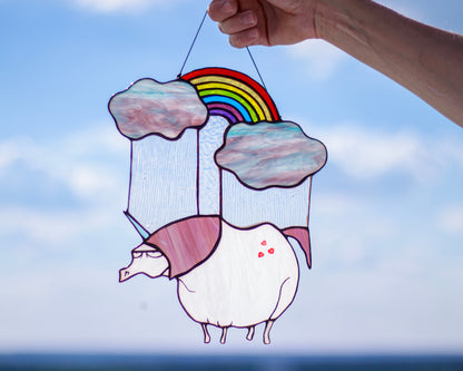 Handmade stained glass sad unicorn suncatcher with rainbow, hanging in window — Mojoartglass