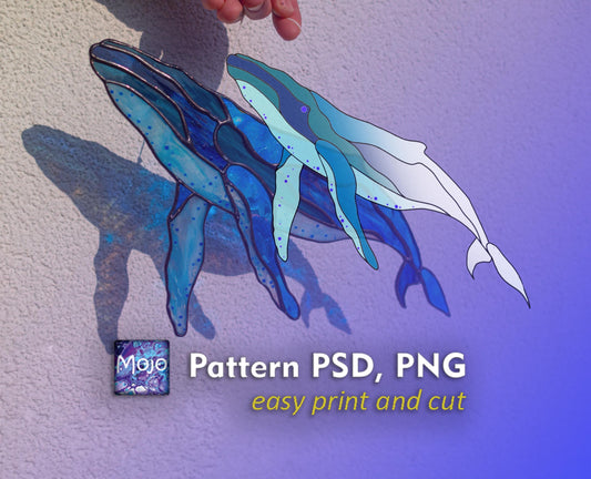 Humpback whale stained glass suncatcher held against wall showing finished result from digital pattern, blue and teal glass with copper foil, Mojoartglass PSD PNG template