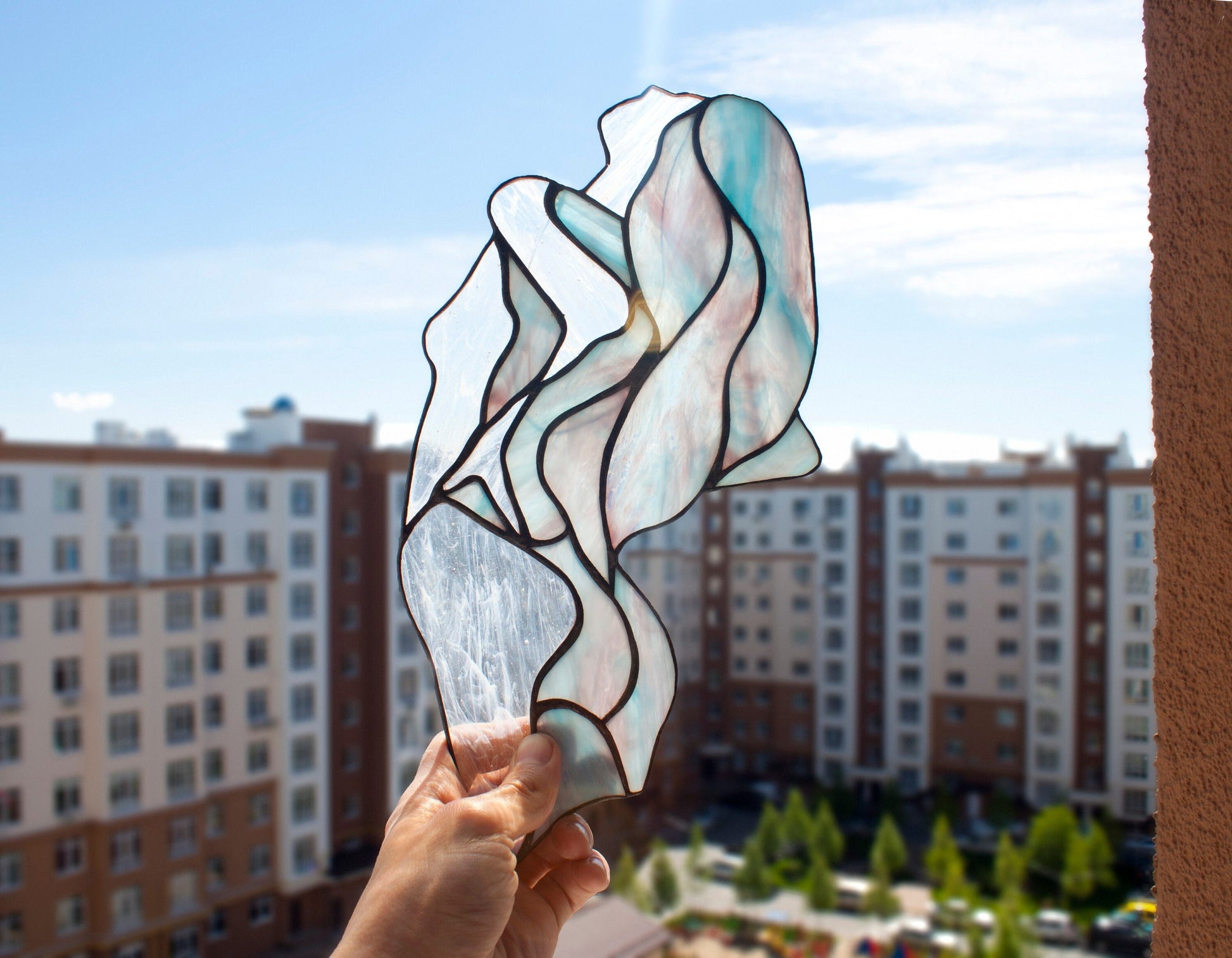 Handmade abstract woman silhouette stained glass suncatcher — flowing feminine form decor